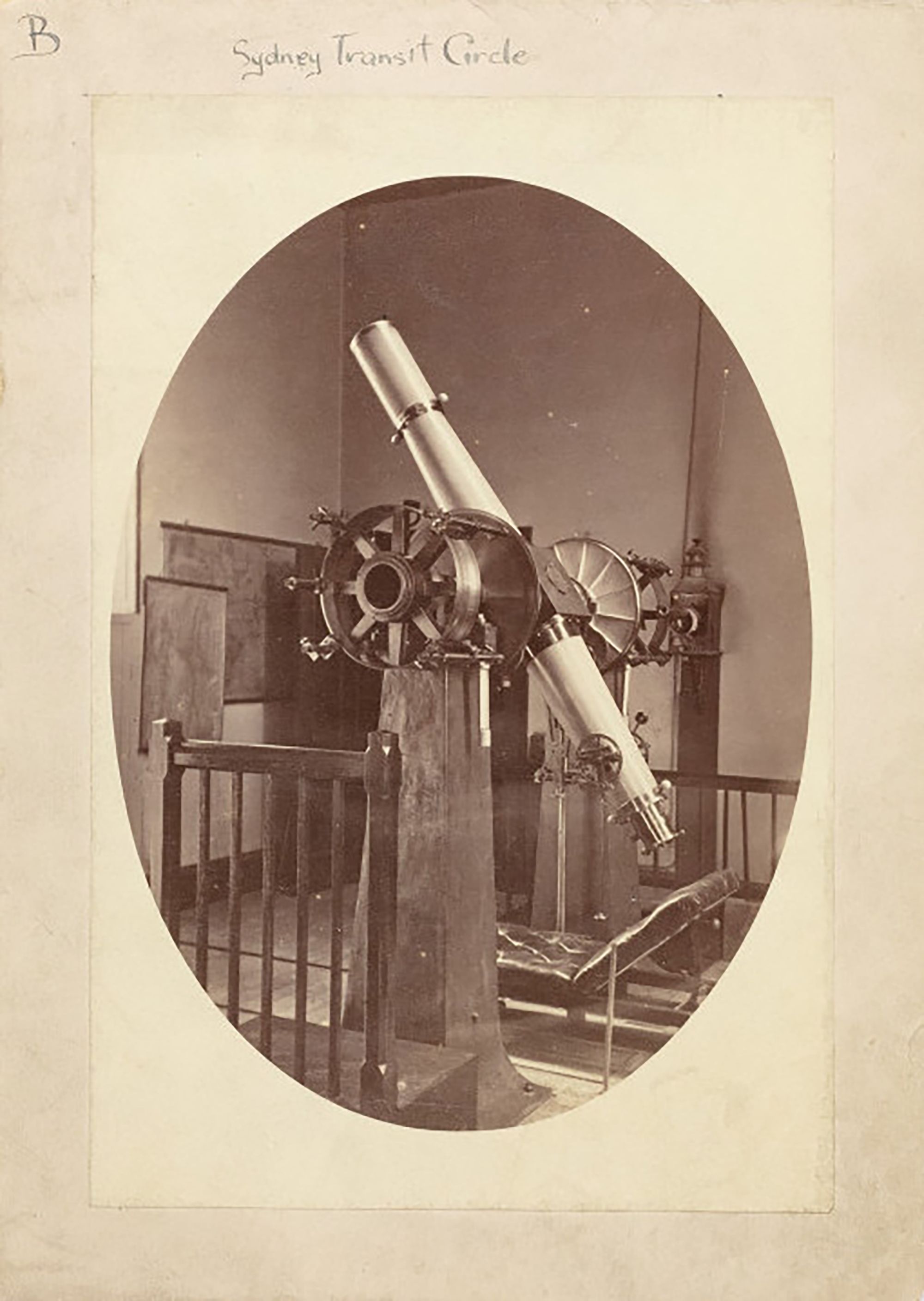 Sepia photographic card showing a vintage telescope