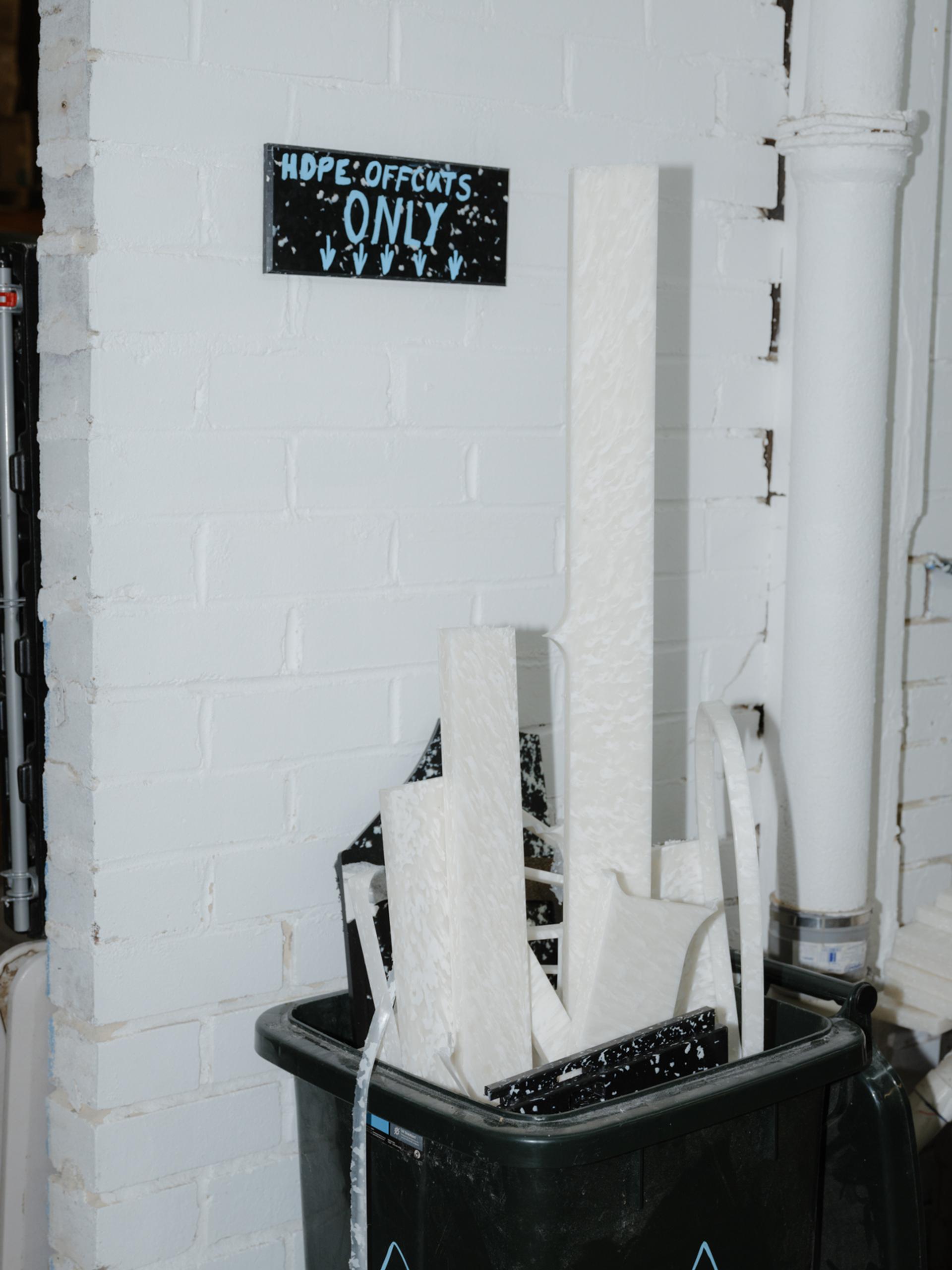 'Hope offcuts only' sign above a bin with offcuts.