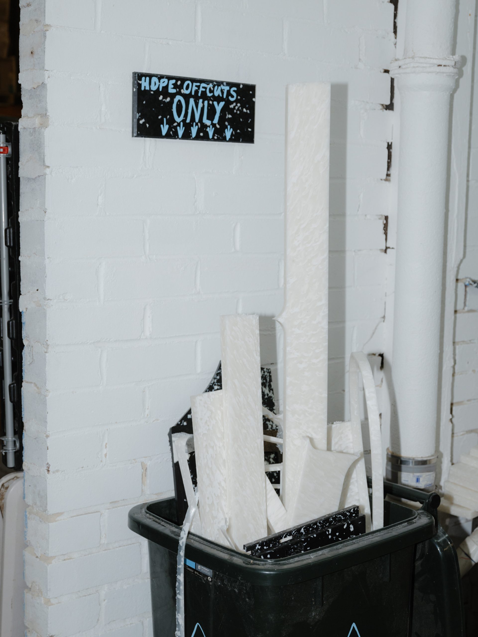 'Hope offcuts only' sign above a bin with offcuts.