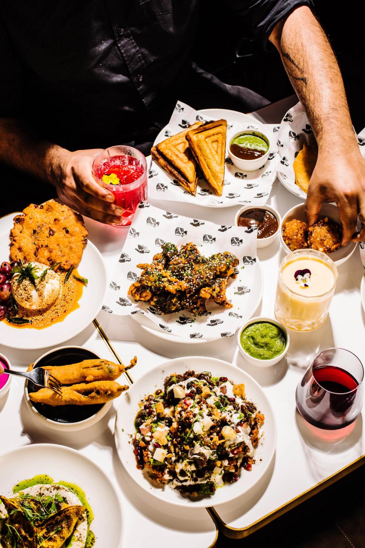 A vibrant spread of Indian dishes laid out on a table.