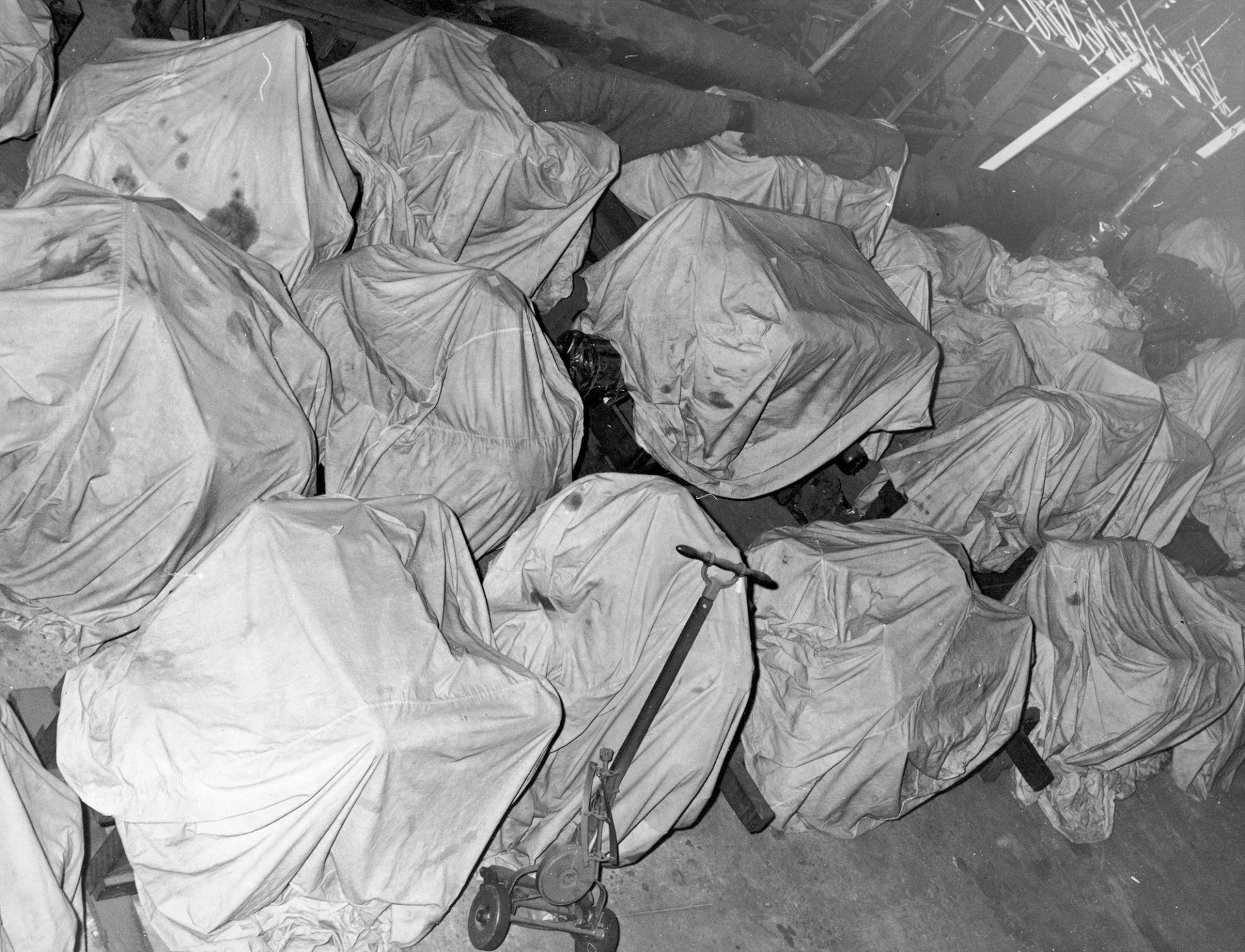 Black and white photograph of covered museum objects