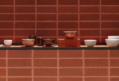 Ceramic bowls displayed on brick plinth.