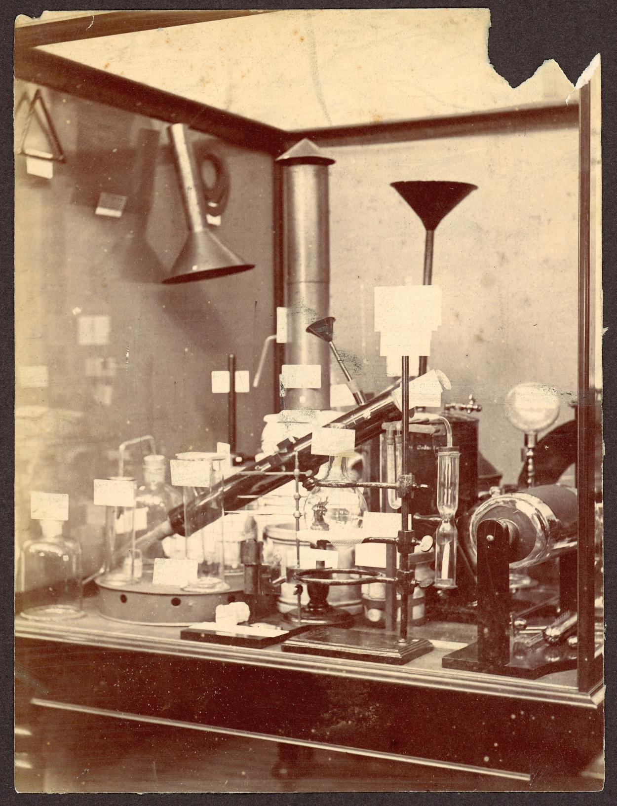 Sepia photograph of chemical equipment inside display case