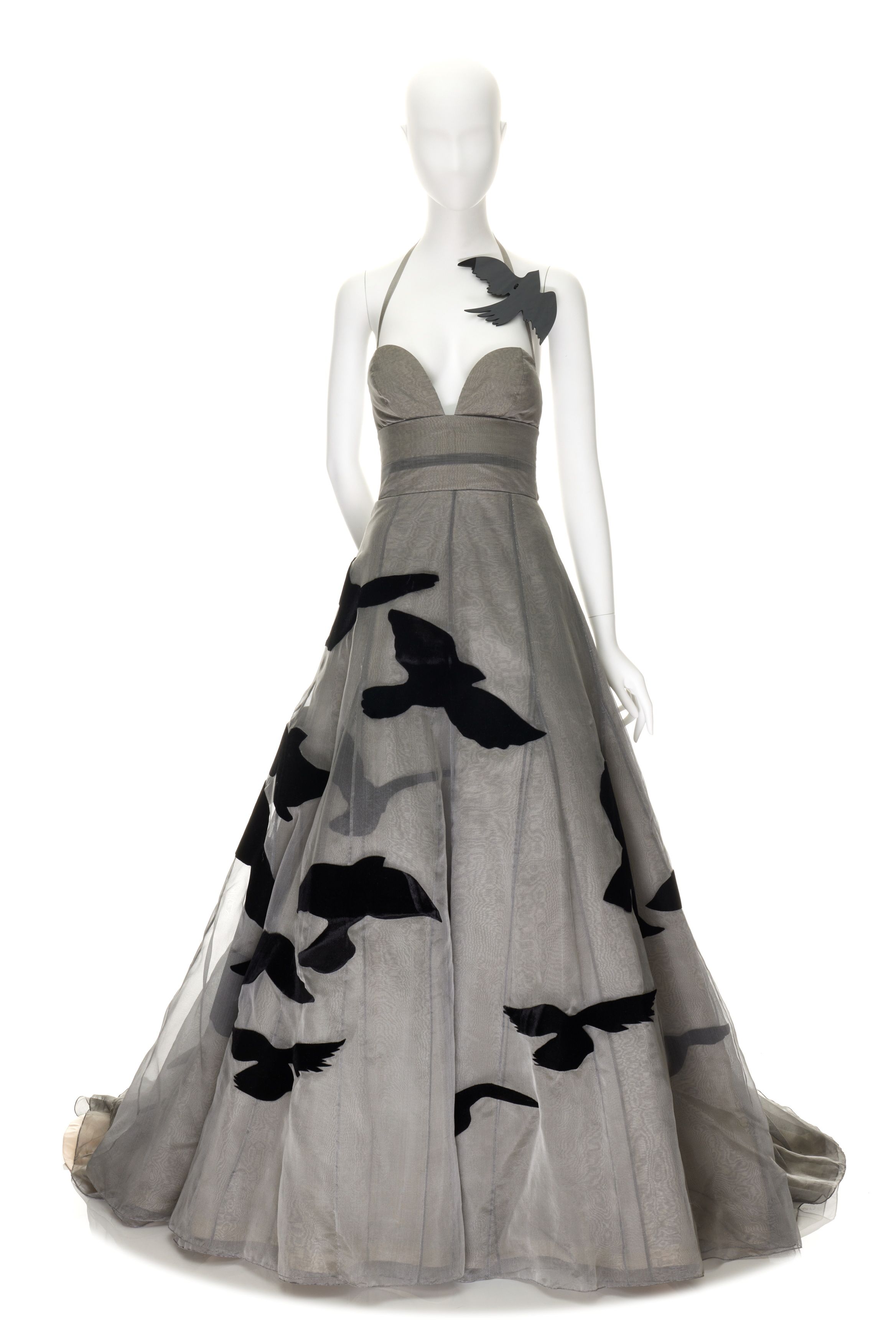 Dark toned evening dress with fabric-shaped birds on it.