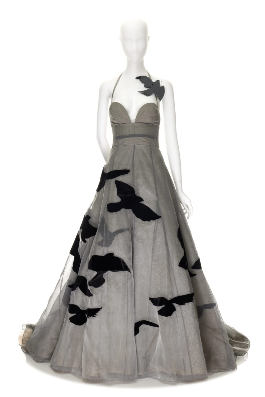 Dark toned evening dress with fabric-shaped birds on it.