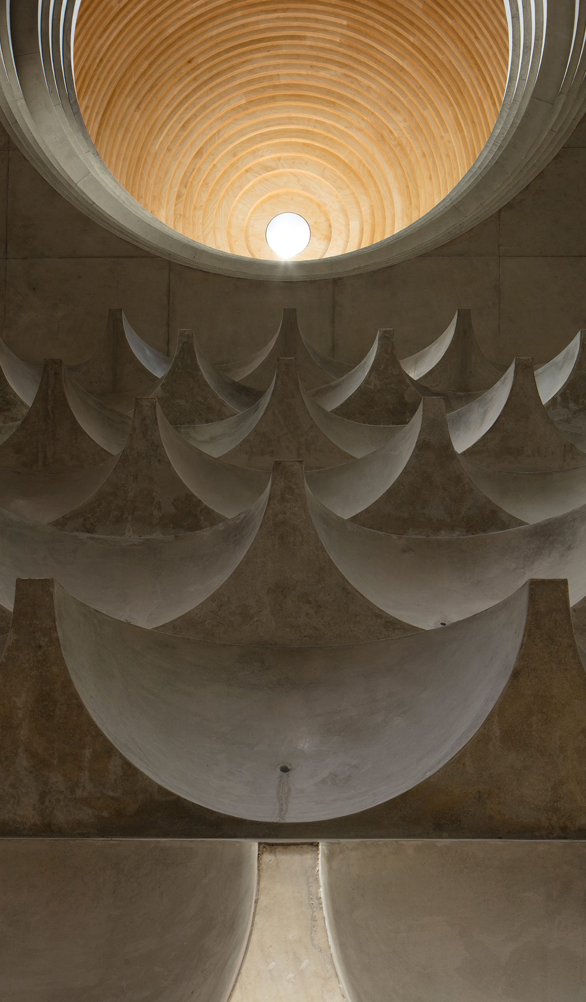 Interior view of mosque ceiling formed from multiple concrete cast half domes and one central timber clad dome