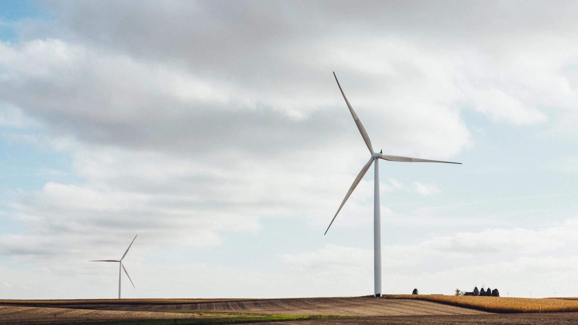 Two wind turbines in a field