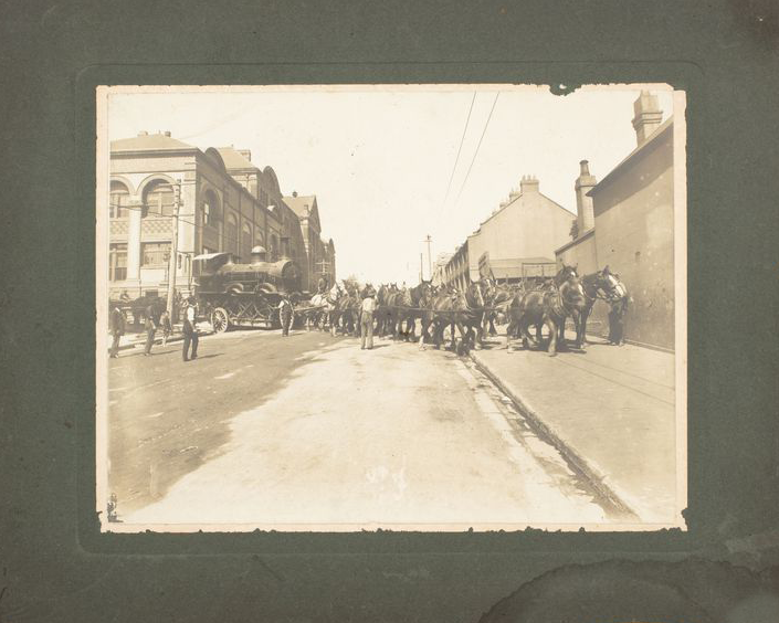 Archival photograph of horses moving a steam train