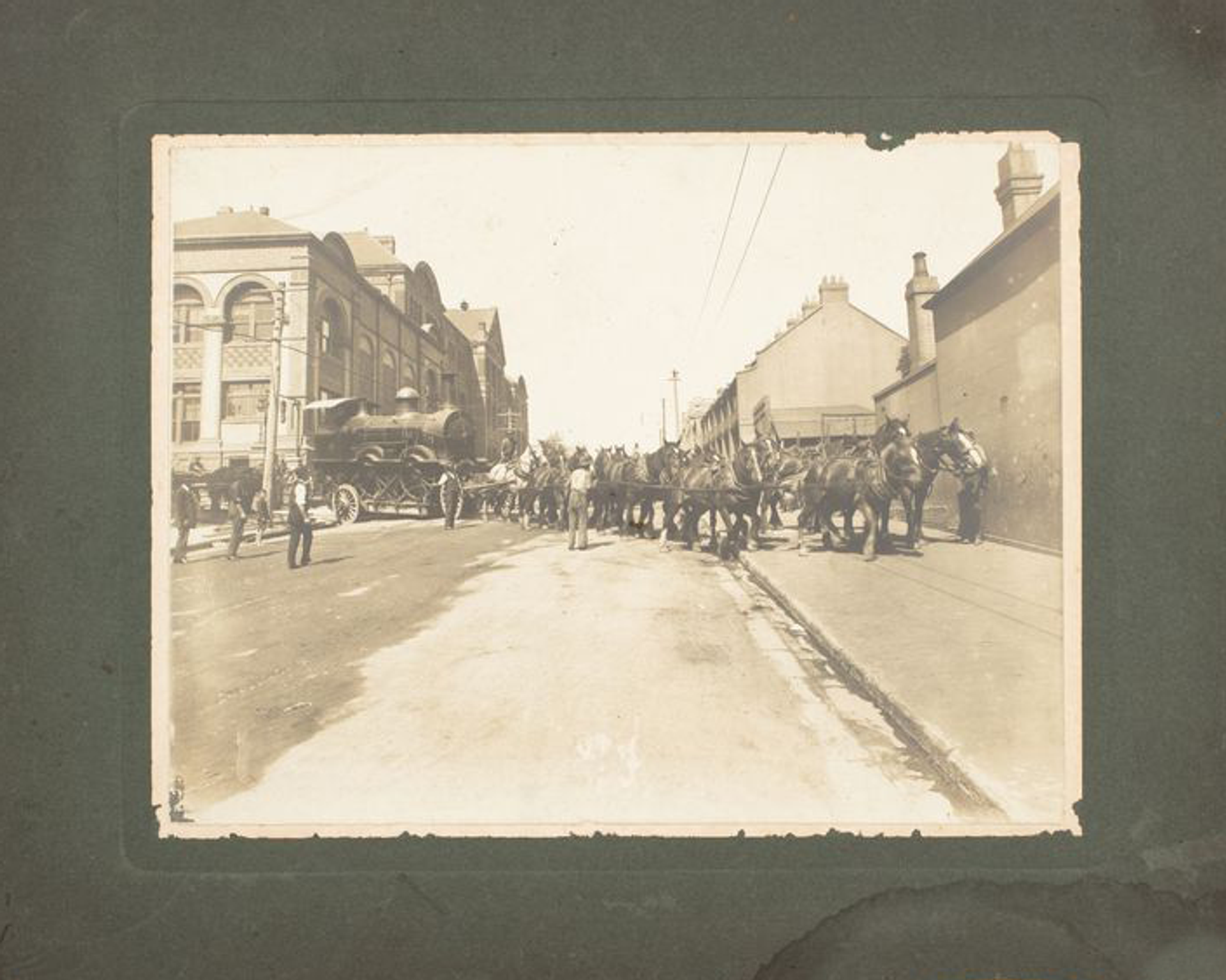 Archival photograph of horses moving a steam train