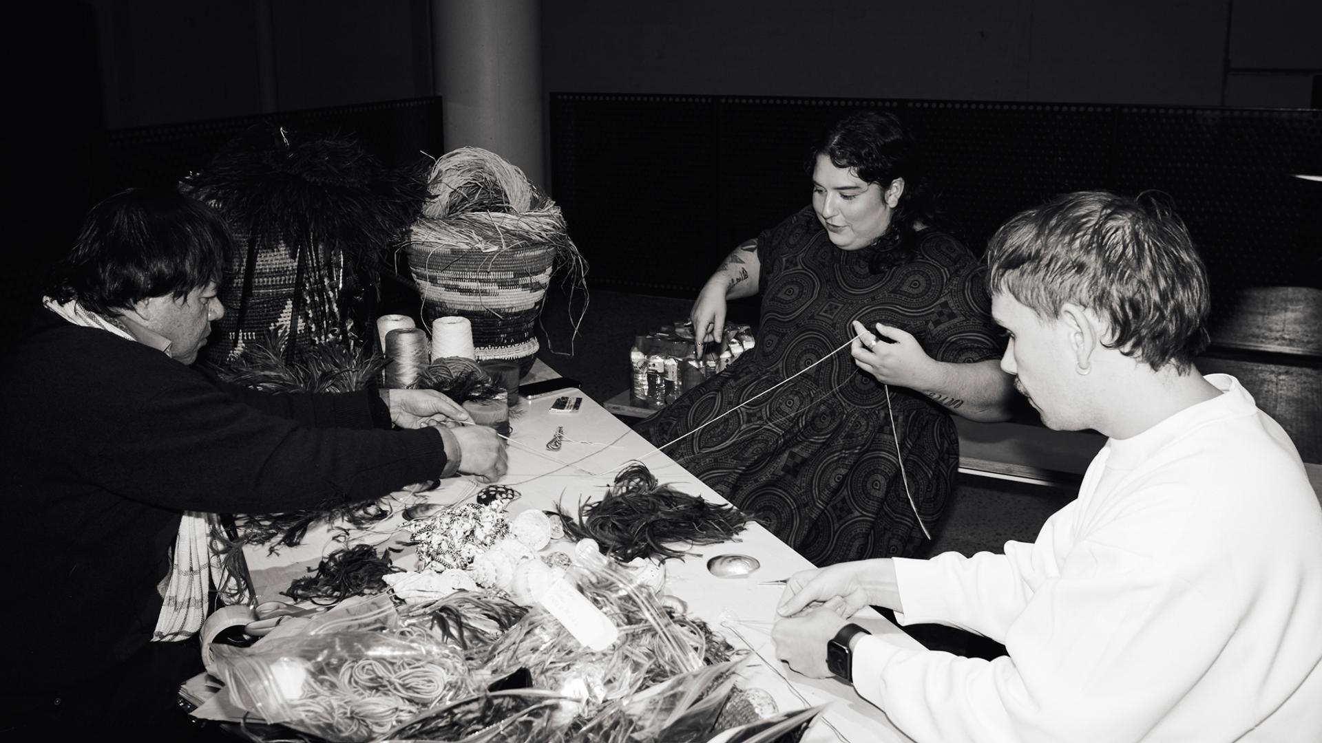 Workshop of 3 people weaving with natural materials