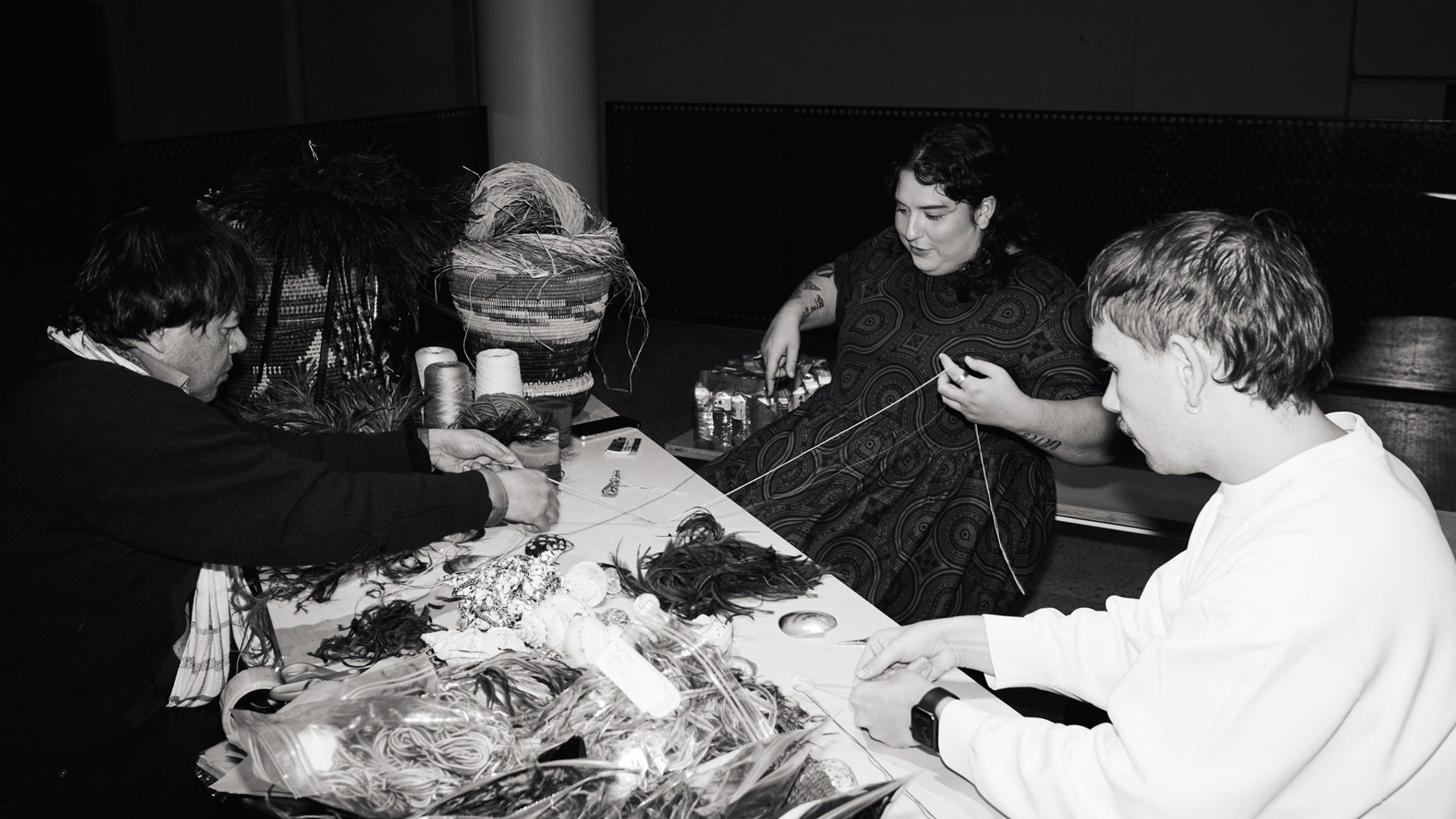 Workshop of 3 people weaving with natural materials