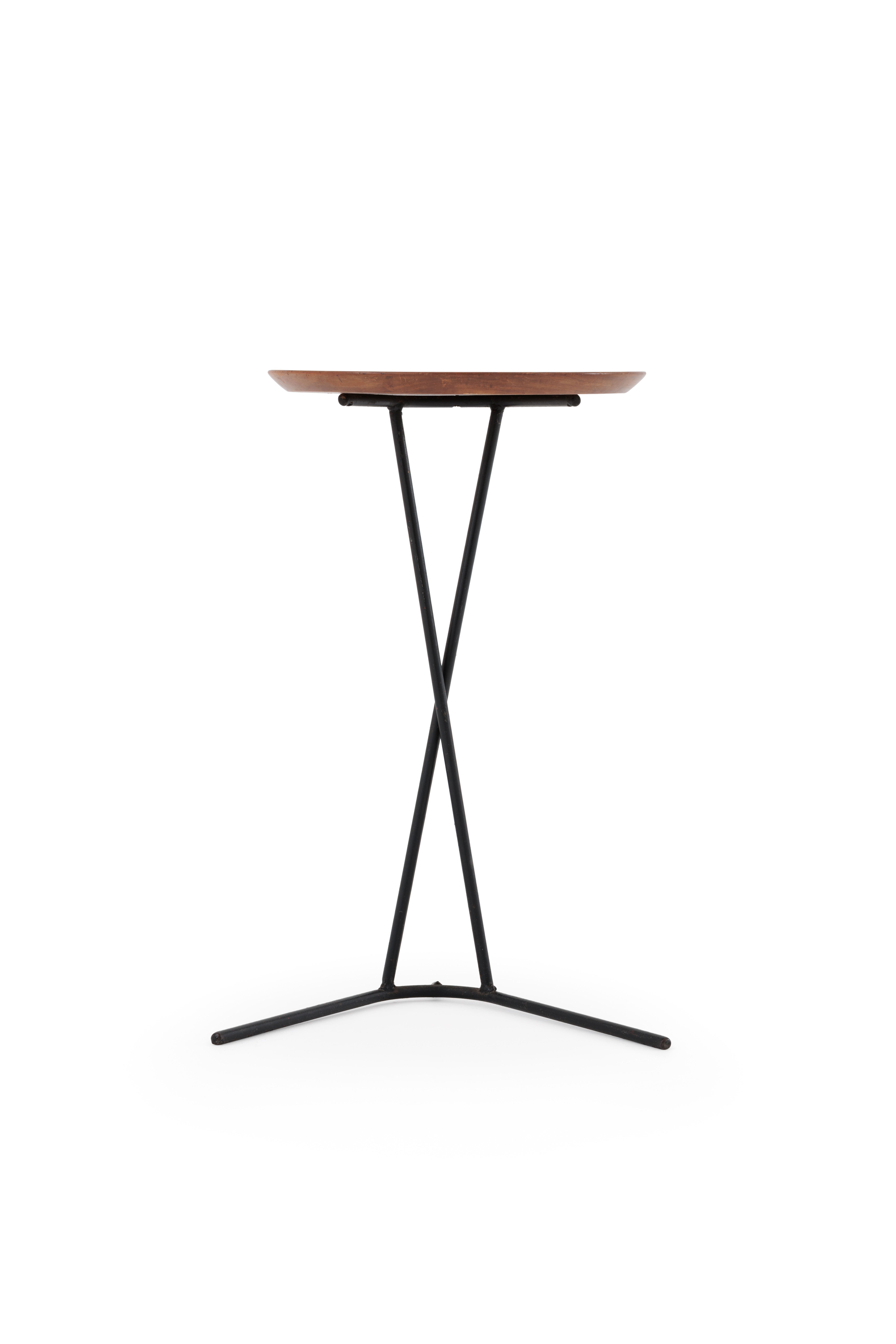 Side table with a timber table top and welded and bent black steel legs.