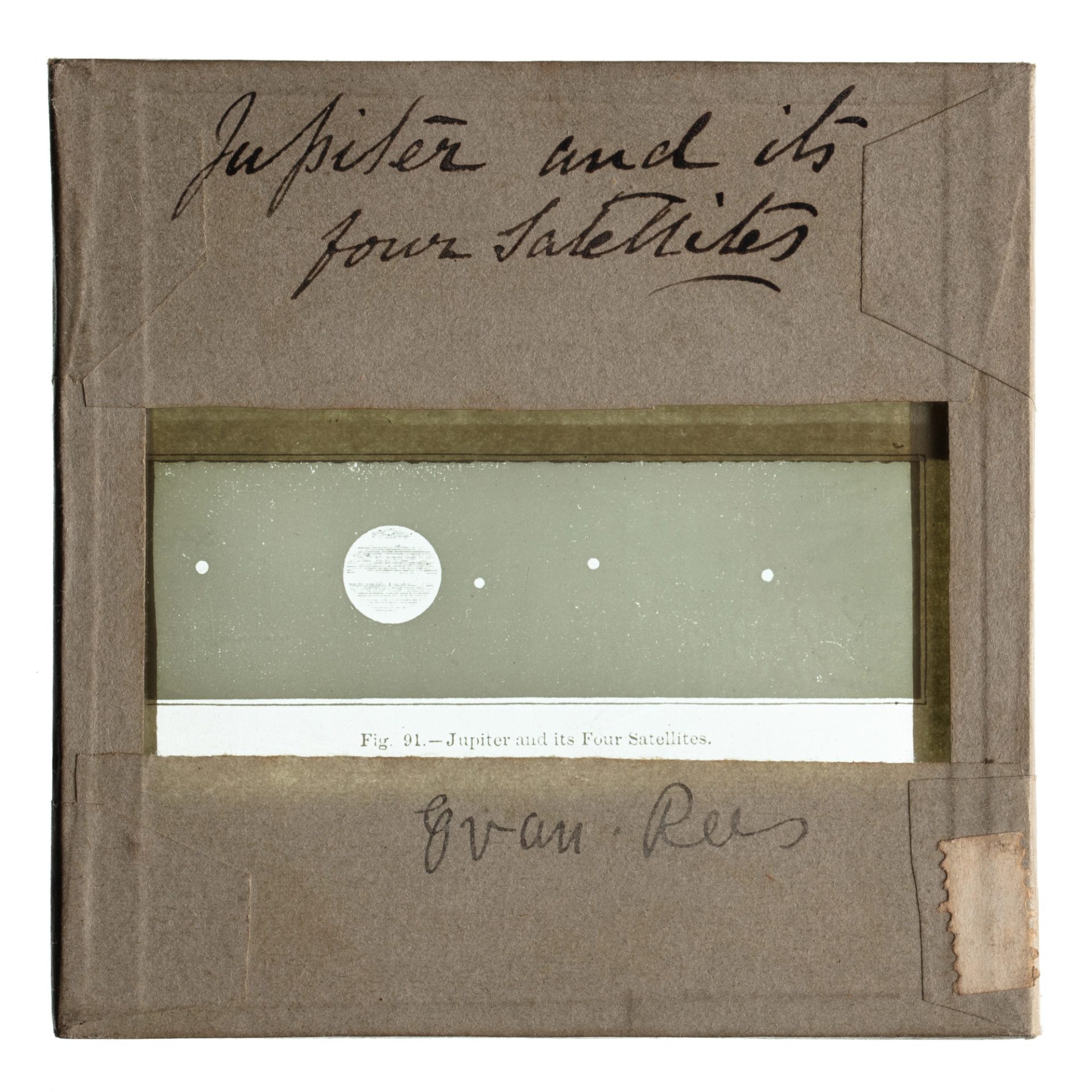 A glass plate slide with borders wrapped in tape, a rectangular window shows Jupiter & its four satellites.
