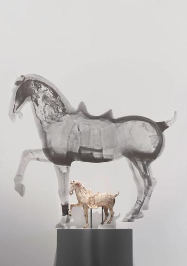 Small horse figure on a plinth in front of a large black and white neutron tomography scan of the same horse figure.