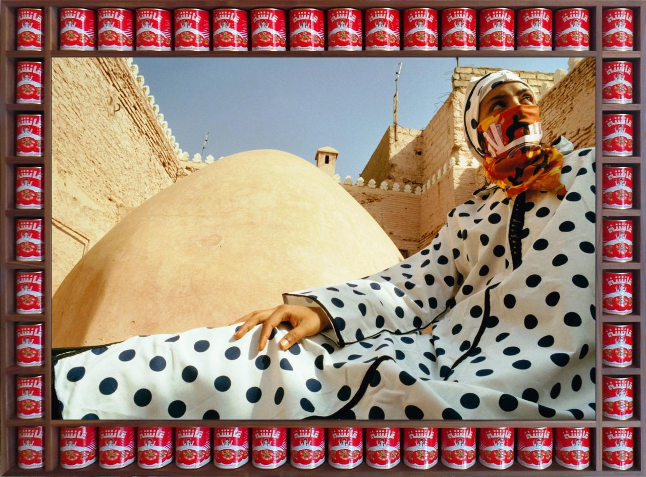 Cans of soup frame the image of a lady wearing dots.