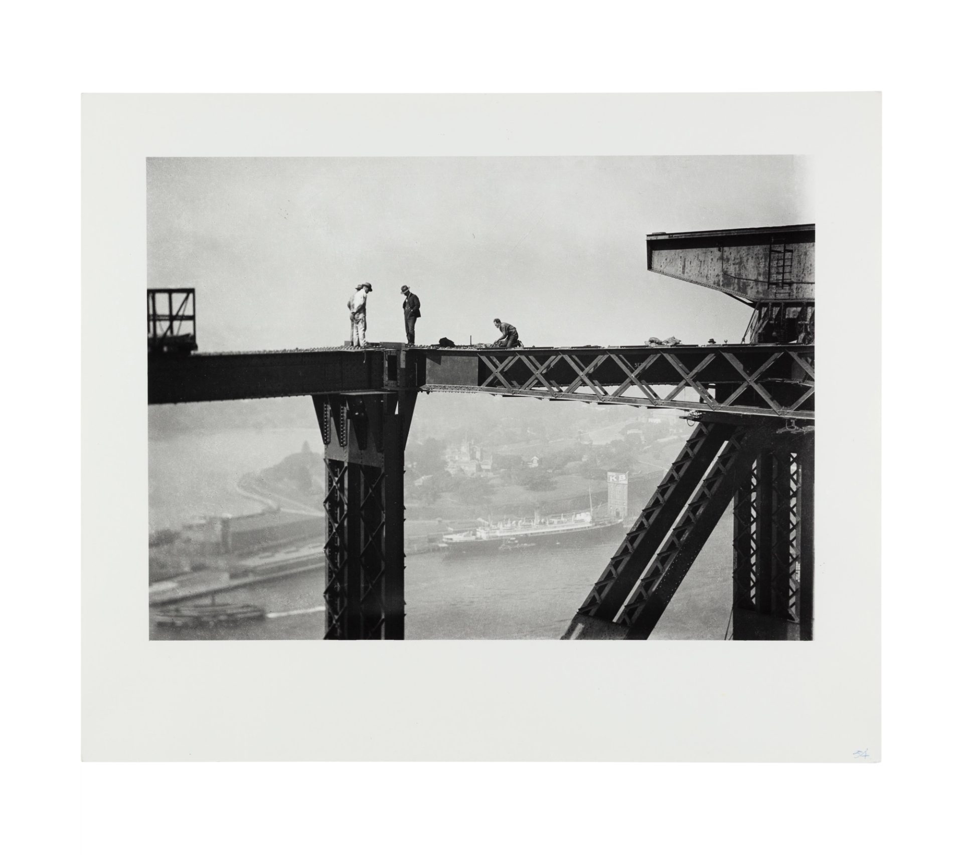 Image of three figures standing on the top of the harbour bridge. A fourth figure is crouched further along the bridge girder to their right. In the background, the harbour is visible below.
