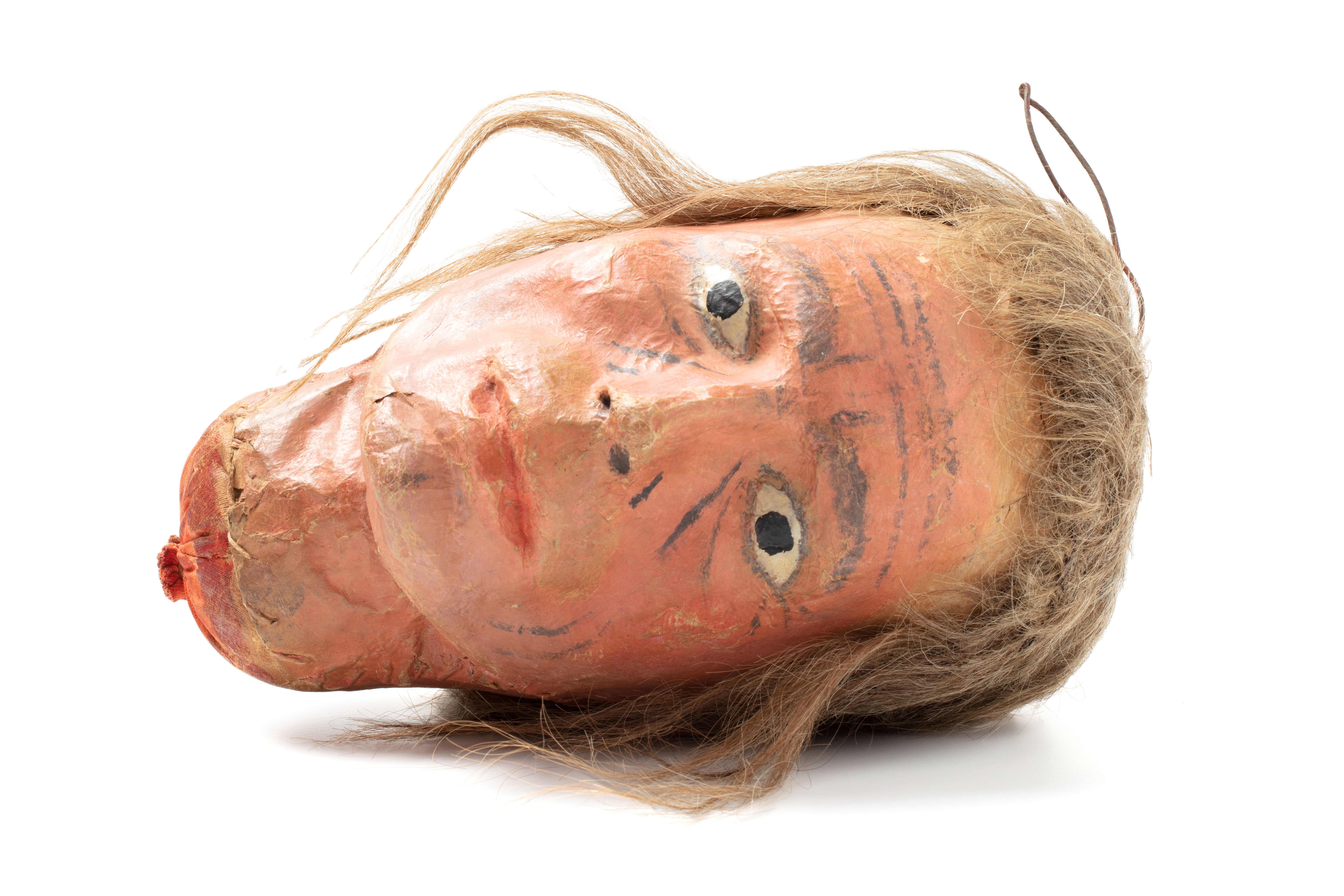 Full size head, made of cloth stuffed with cotton wool; face and neck modelled of papier-mâché & painted. Includes light brown hair sewn onto head as a wig.