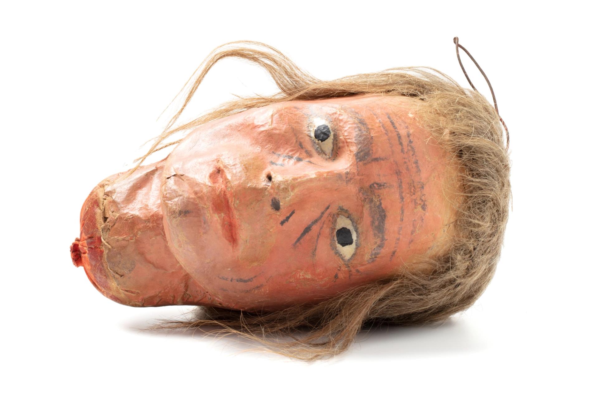 Full size head, made of cloth stuffed with cotton wool; face and neck modelled of papier-mâché & painted. Includes light brown hair sewn onto head as a wig.