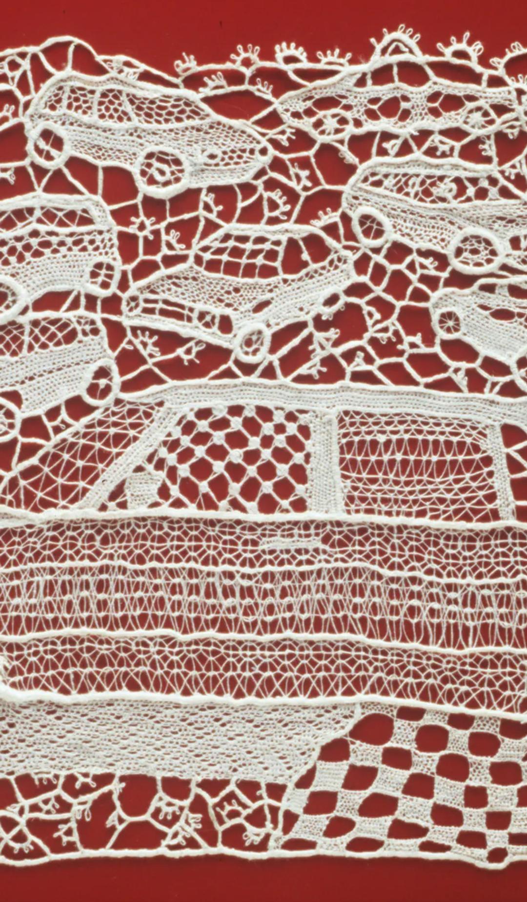 Rectangular lace panel, in 120 ecru linen thread, depicting a profile of a large car in the foreground with a number of small cars in the 3/4 profile randomly scattered in the background. All worked in many different needle-lace stitch patterns. Mounted with nylon thread onto red painted sheet of metal referencing a car door.