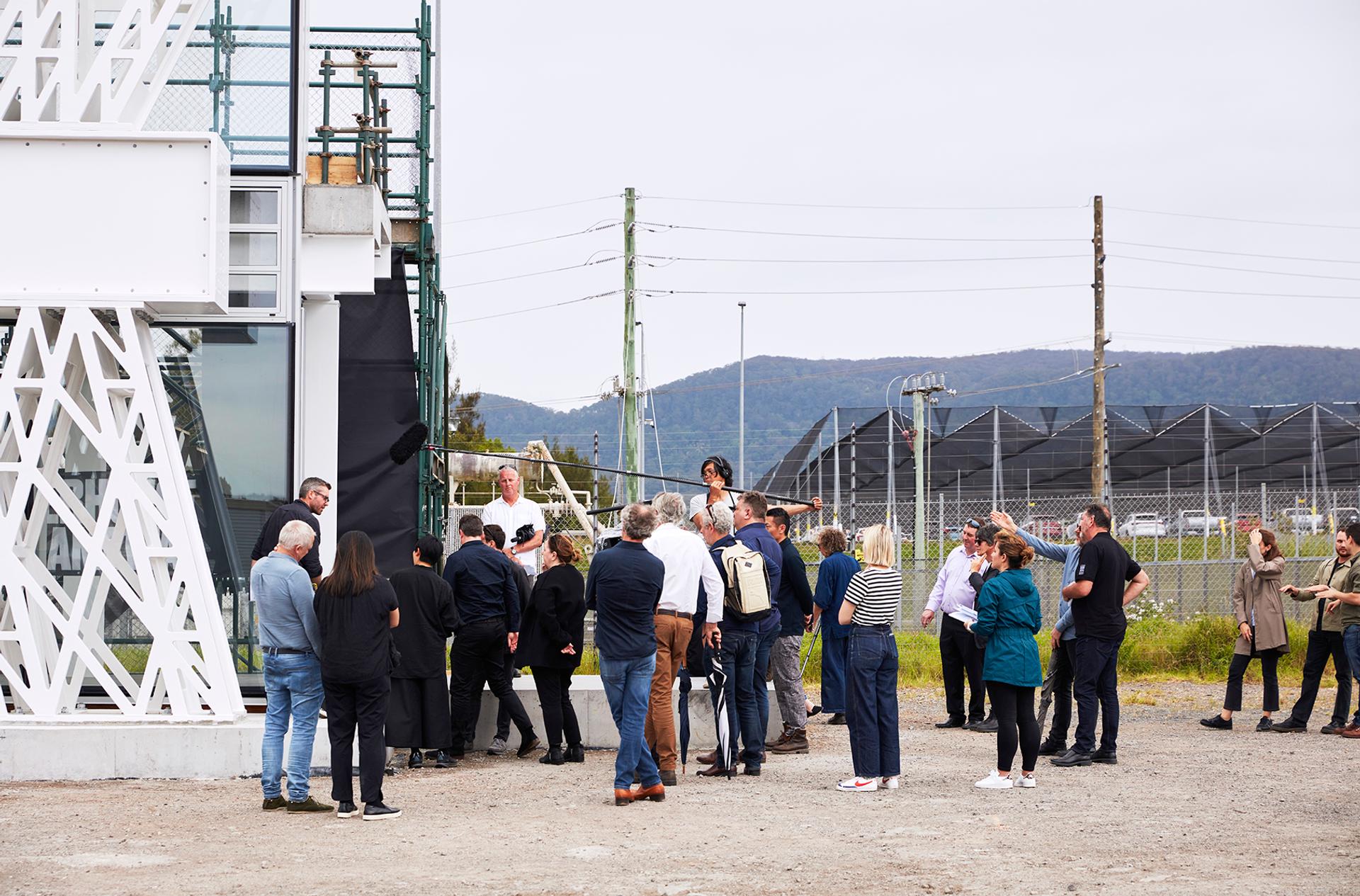 people gathered outside prototype under a boom mic