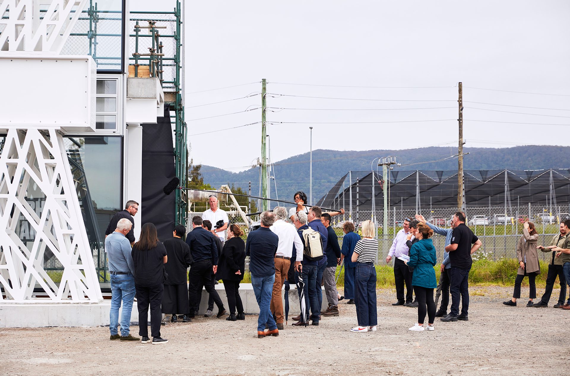 people gathered outside prototype under a boom mic