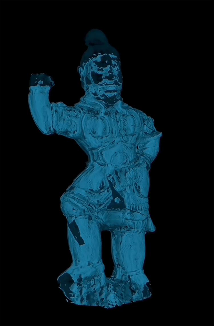 A blue and black scan of a small warrior figure against a black background.