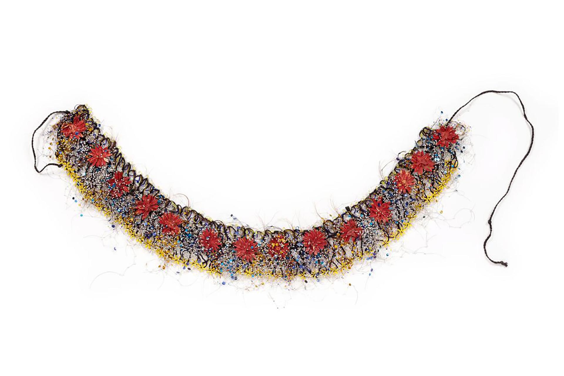Black synthetic-braid, loosely looped and sewn into a waistband onto which is threaded horsehair strung with a variety of coloured ornaments.