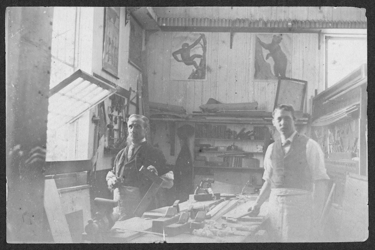 Black and white photograph of two men as a workbench