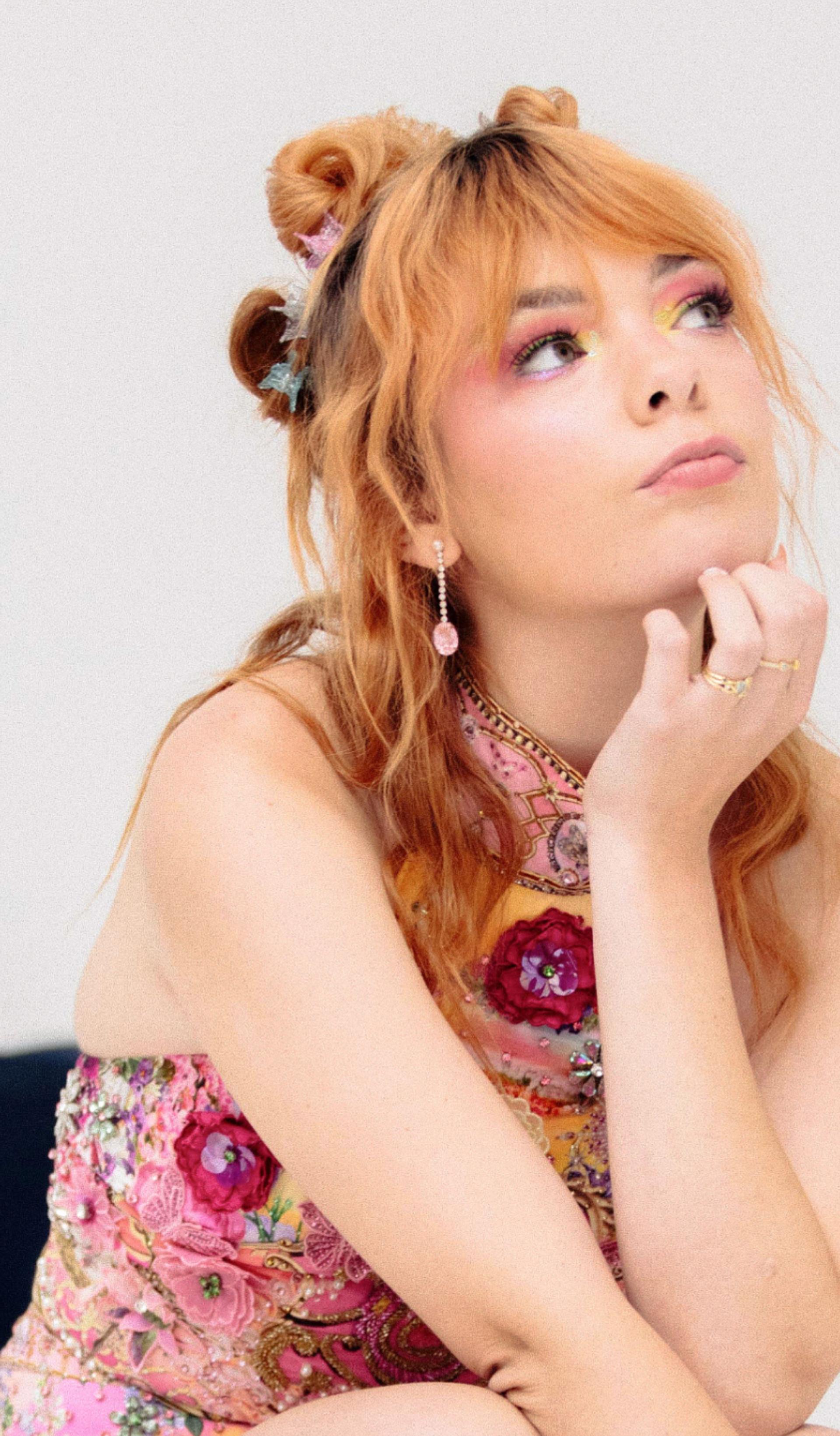 Activist Chloe Hayden posed against a white background and eclectic Powerhouse Collection objects.