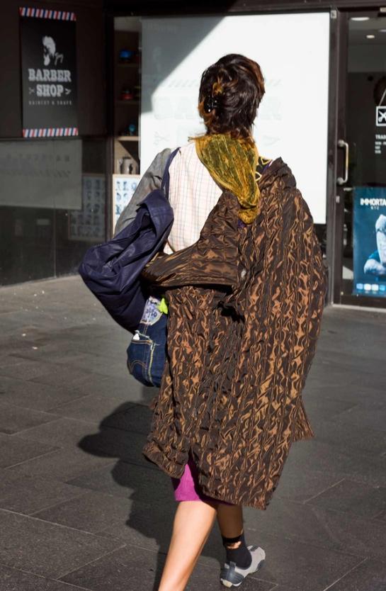 Person from behind wearing an eclectic assortment of clothes.