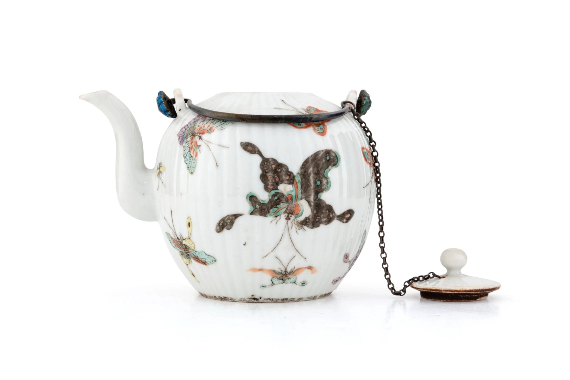 A white porcelain teapot with butterfly illustrations in various colours.