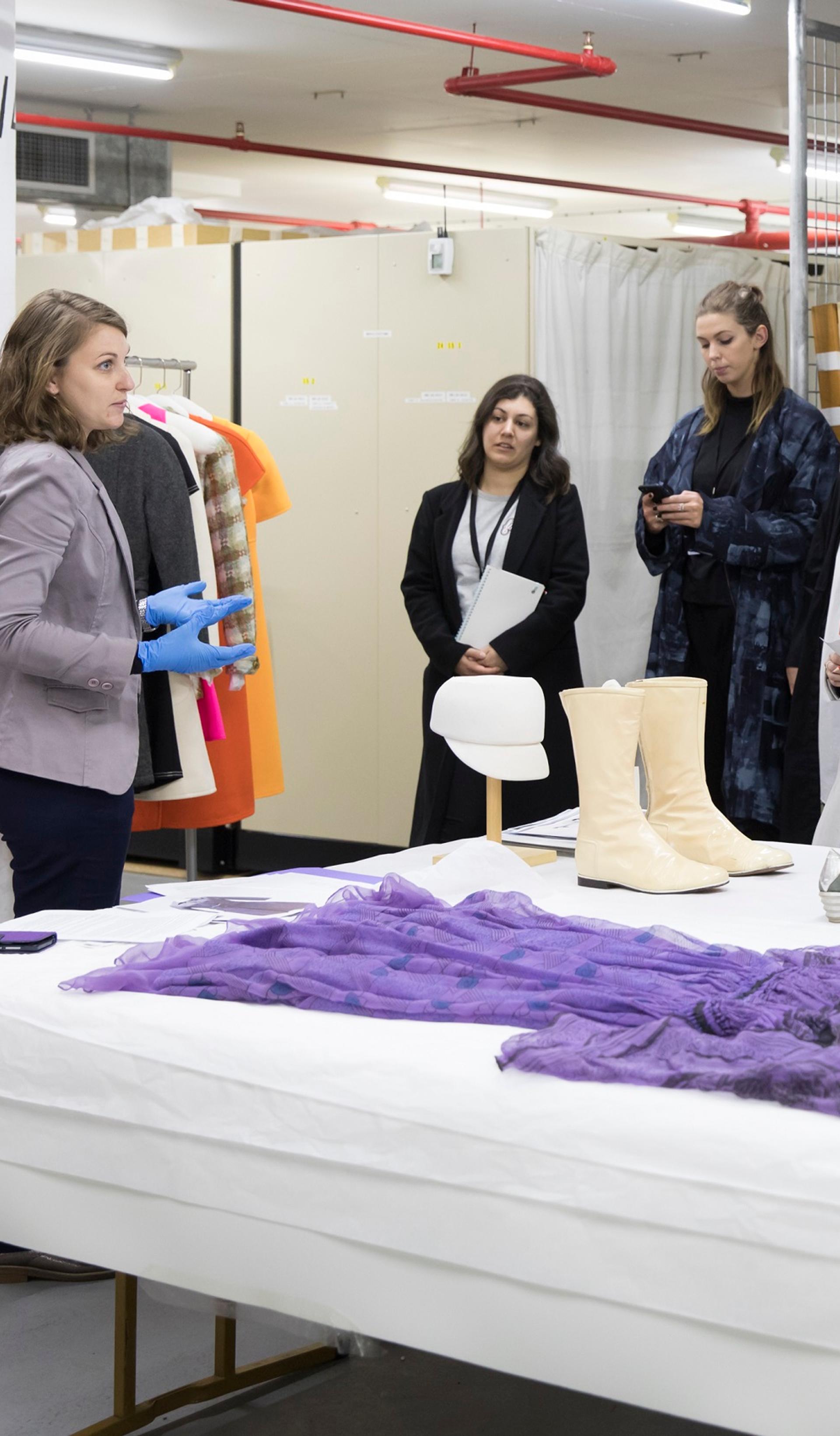 Curator Vanessa Thorne showing objects from the collection in storage