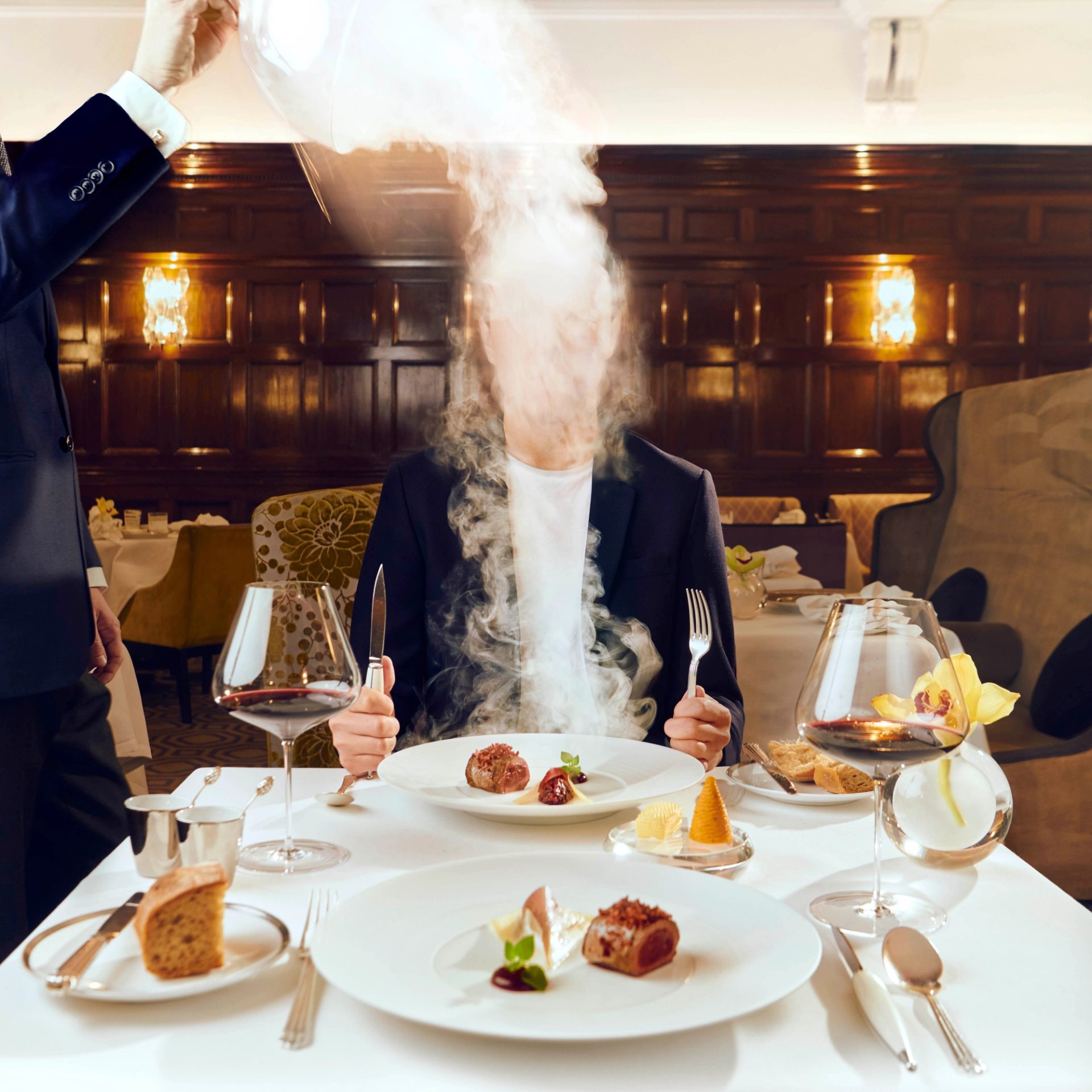 Smoke flying in front of diners face at a restaurant.