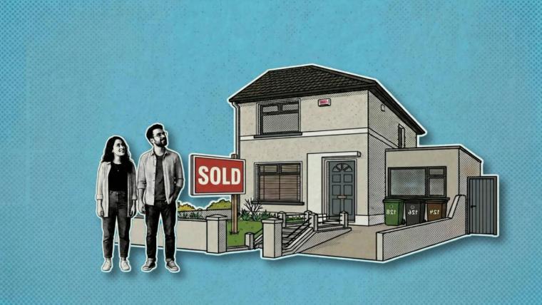 A couple standing beside their new home with a sold sign.