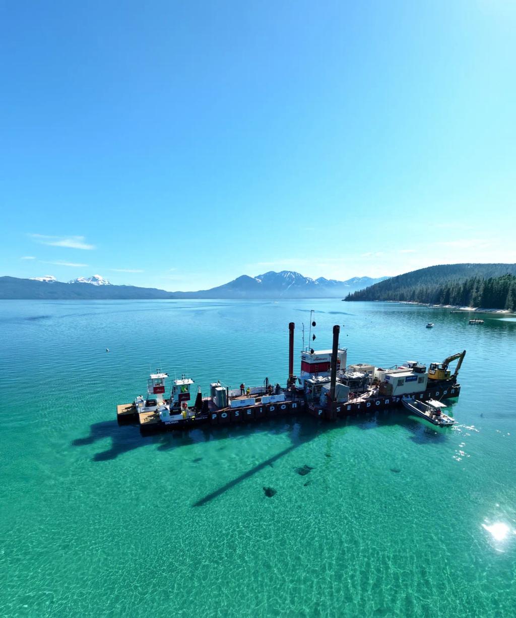 A work barge on the turquoise water of Lake Tahoe.