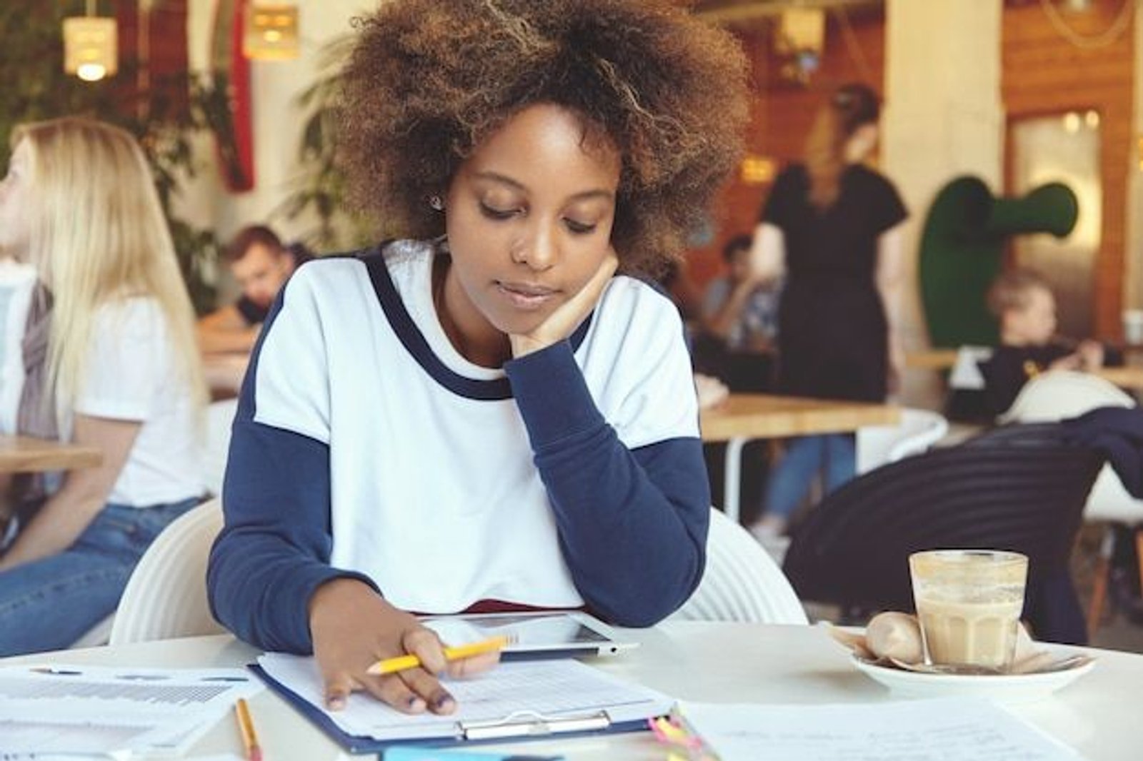 young student in cafe reading