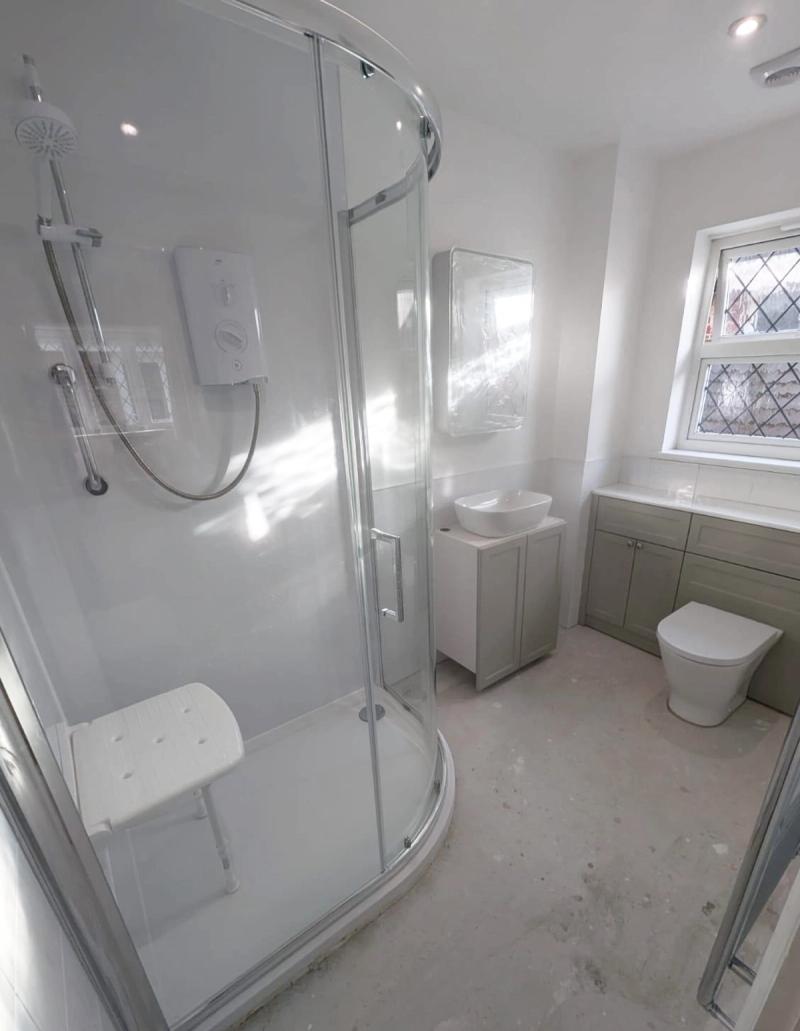 Accessible curved shower and grey vanity