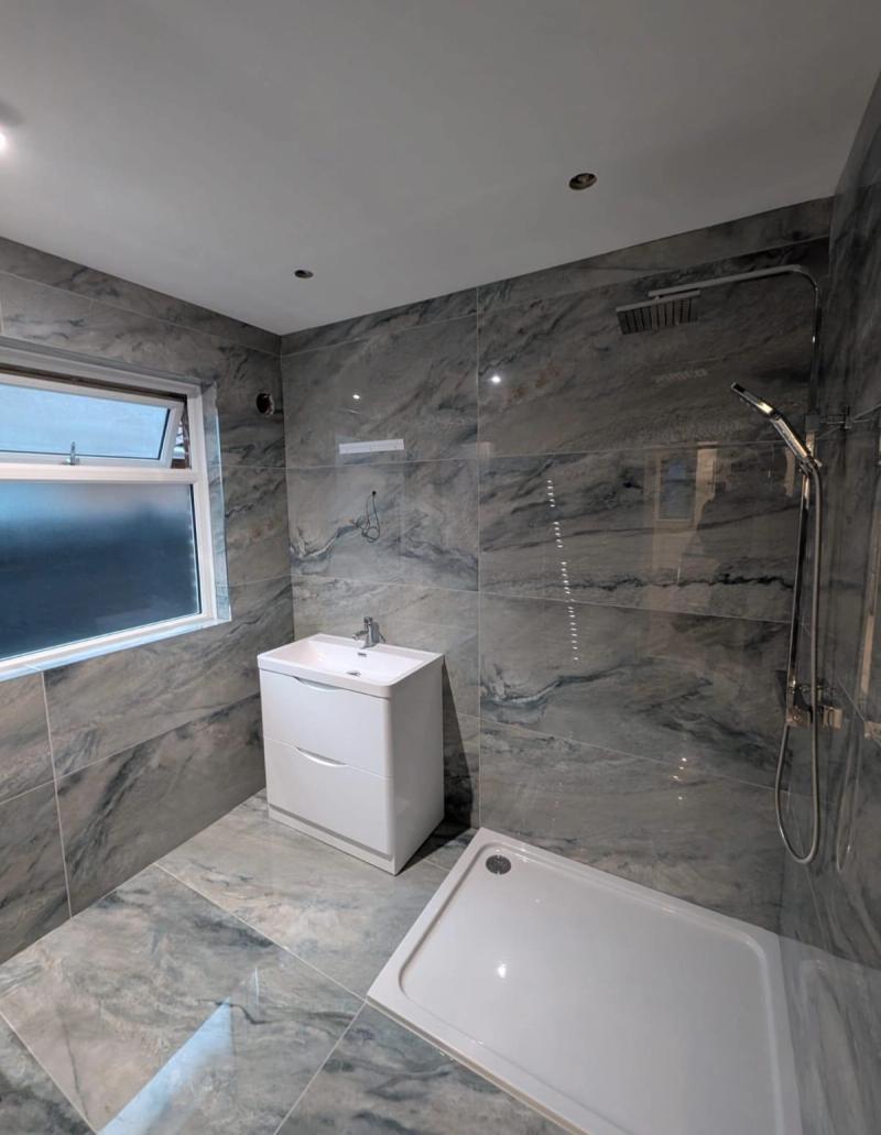 Grey marble-tiled shower and vanity