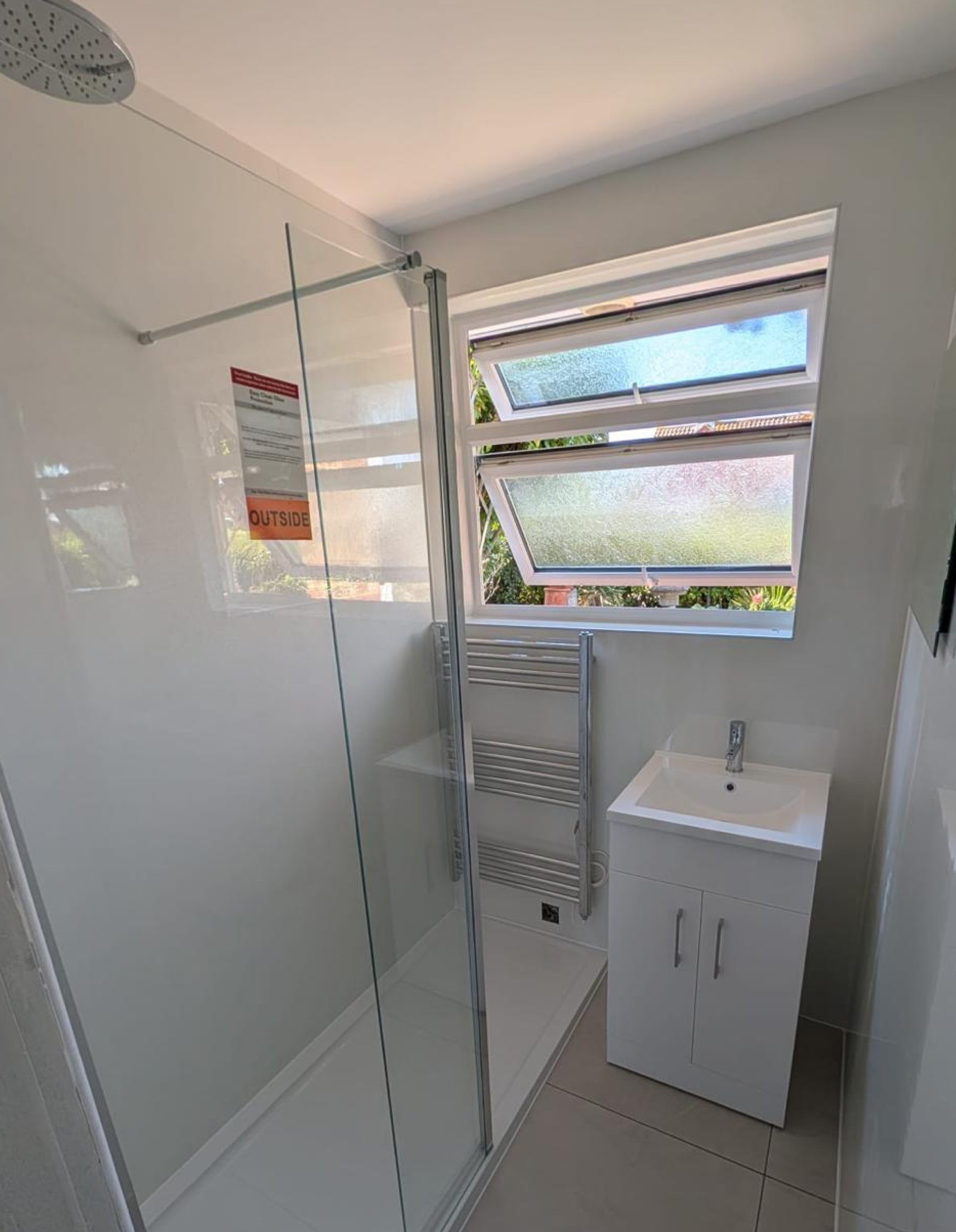 Narrow bathroom with walk-in shower and vanity