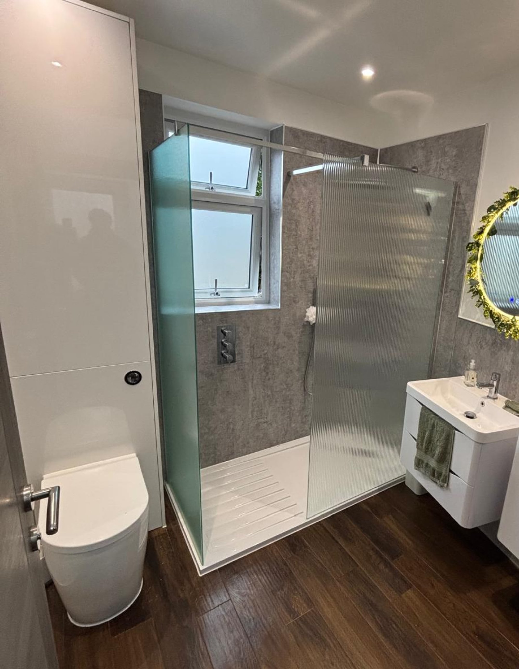 Bathroom with ribbed glass shower and toilet