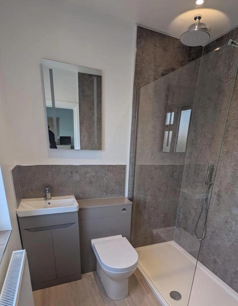 Grey bathroom with shower enclosure and toilet