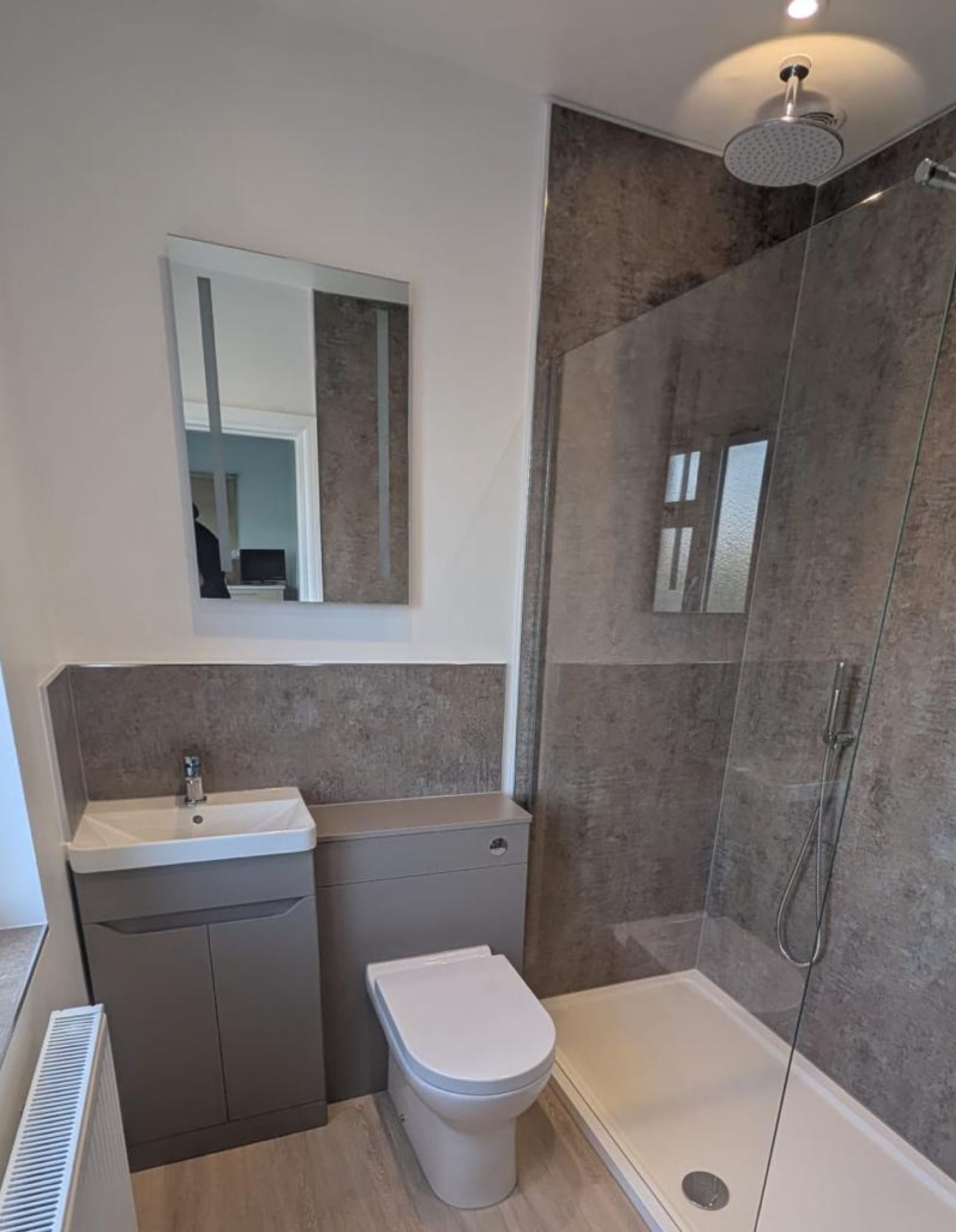 Grey bathroom with shower enclosure and toilet