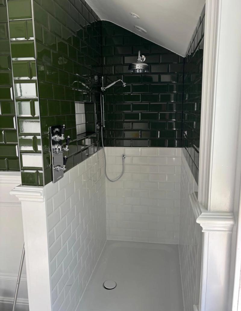 Green and white tiled walk-in shower