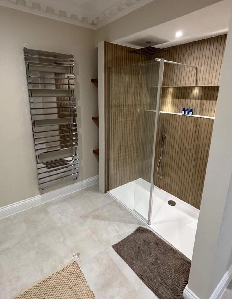Wood slat walk-in shower with glass screen