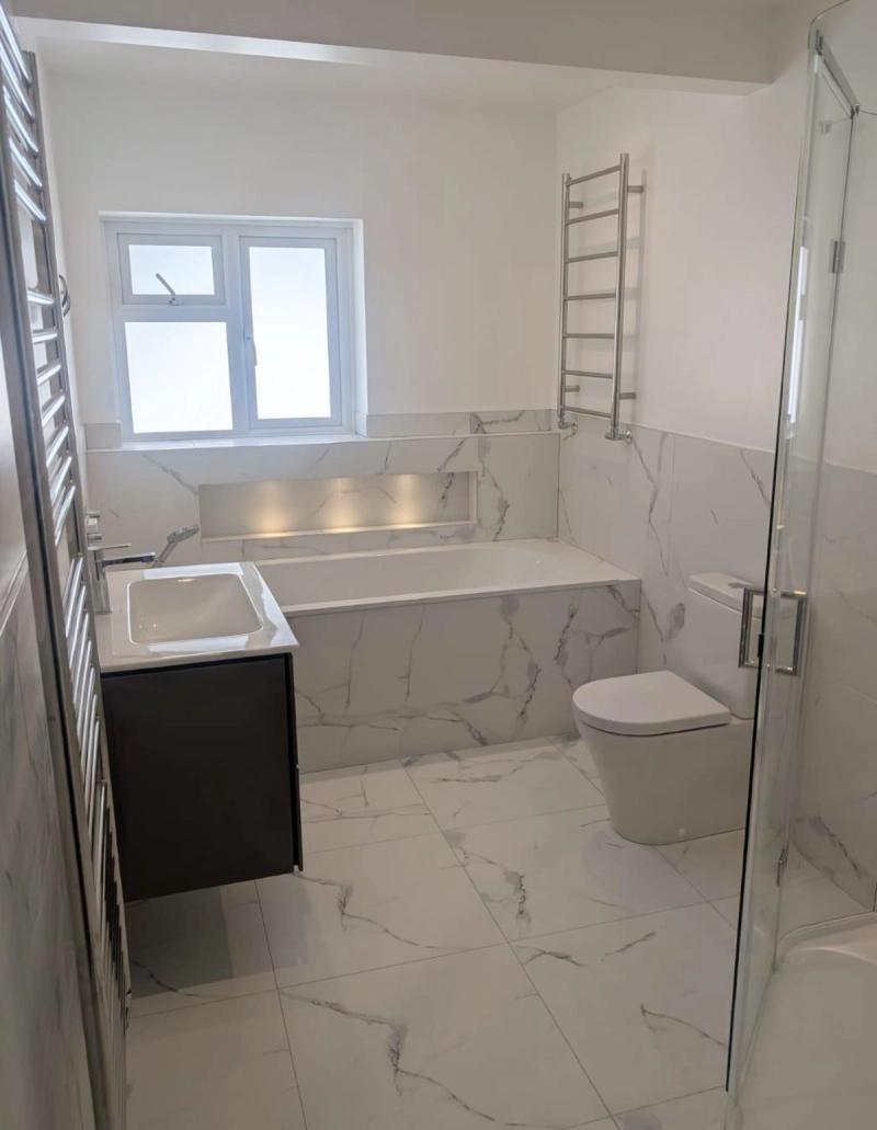 Marble bathroom with bathtub, toilet and shower
