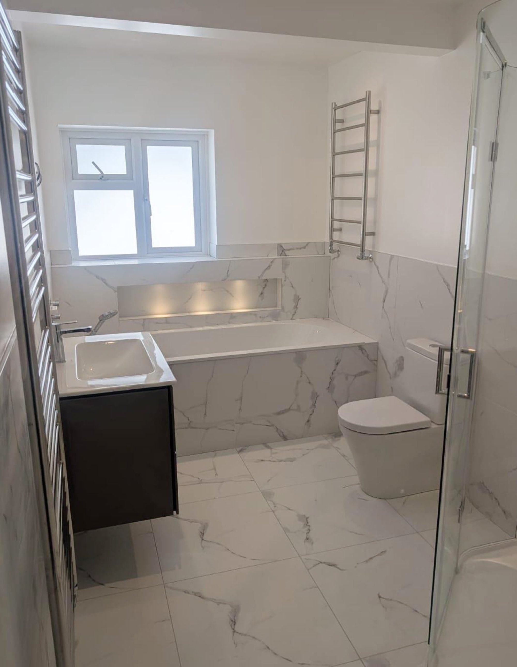 Marble bathroom with bathtub, toilet and shower