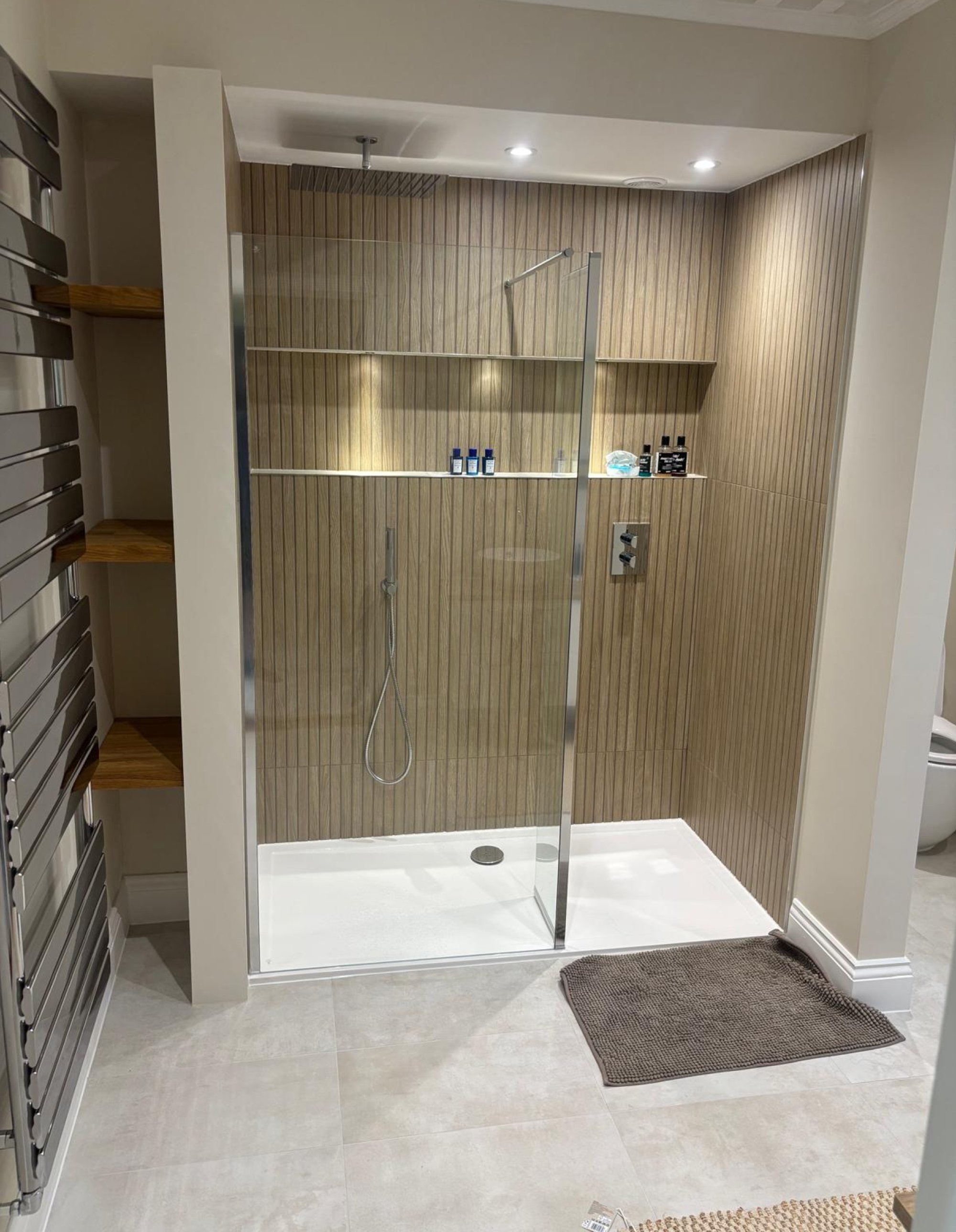 Wood slat walk-in shower with recessed shelves