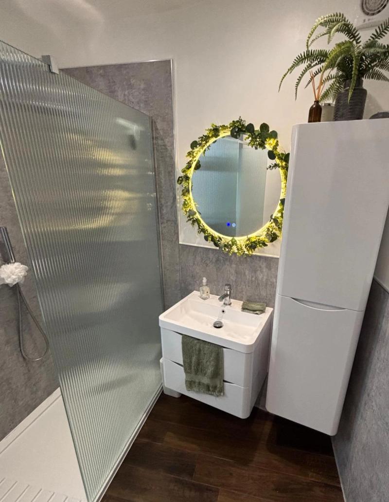 Bathroom vanity with illuminated greenery mirror