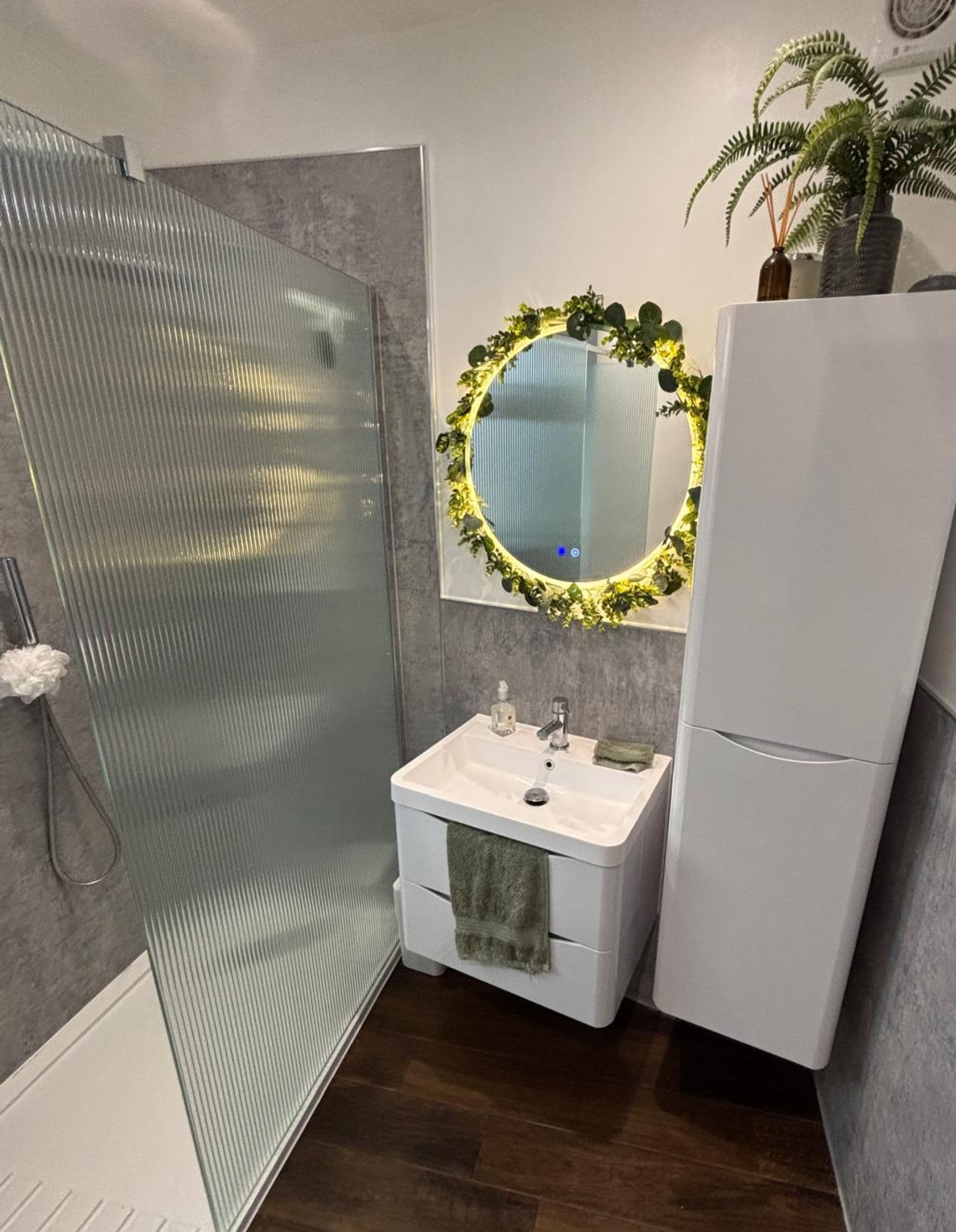 Bathroom vanity with illuminated greenery mirror
