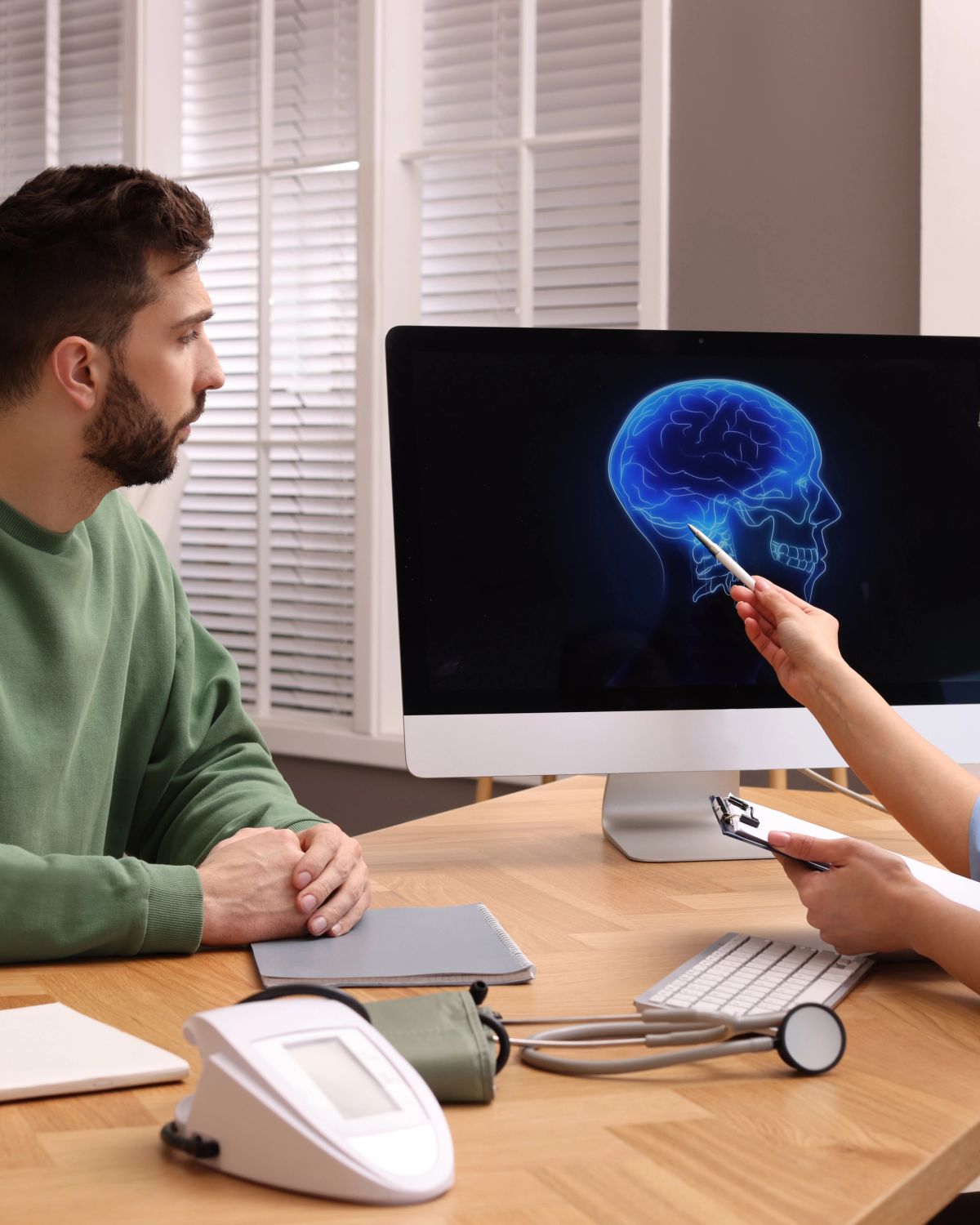 A clinician reviews brain imaging with a patient